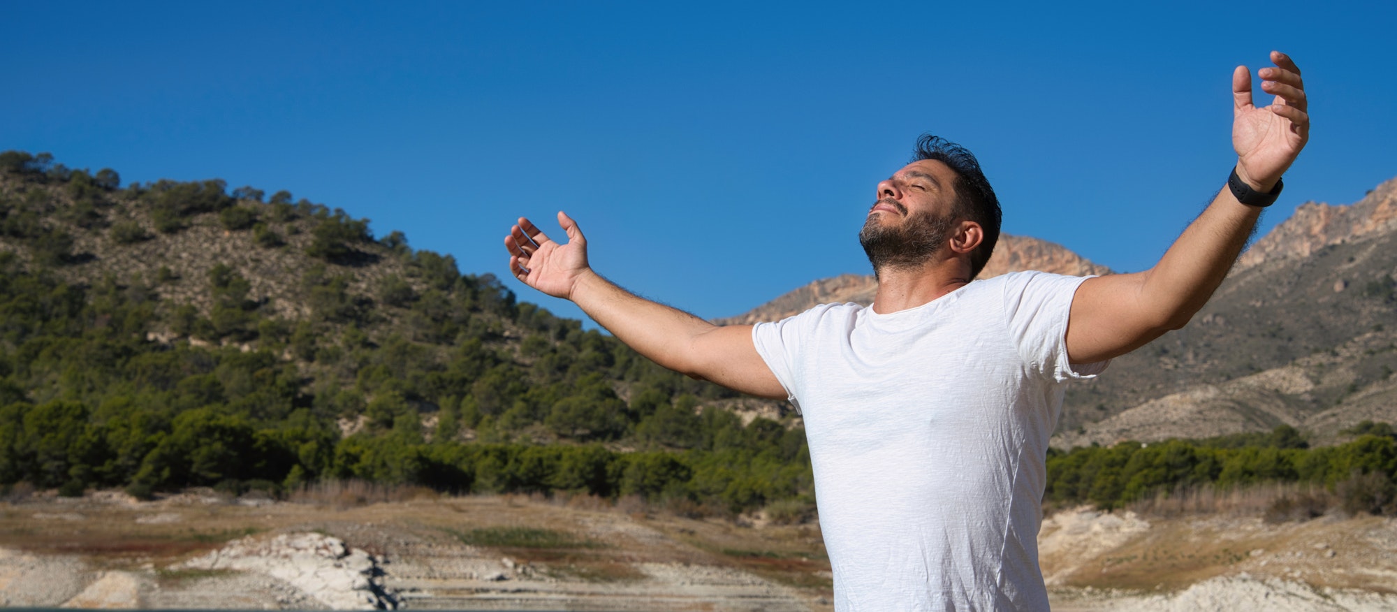 Adult Man Breathing Fresh Air in the Park or Forest. Balance and Vitamin D.